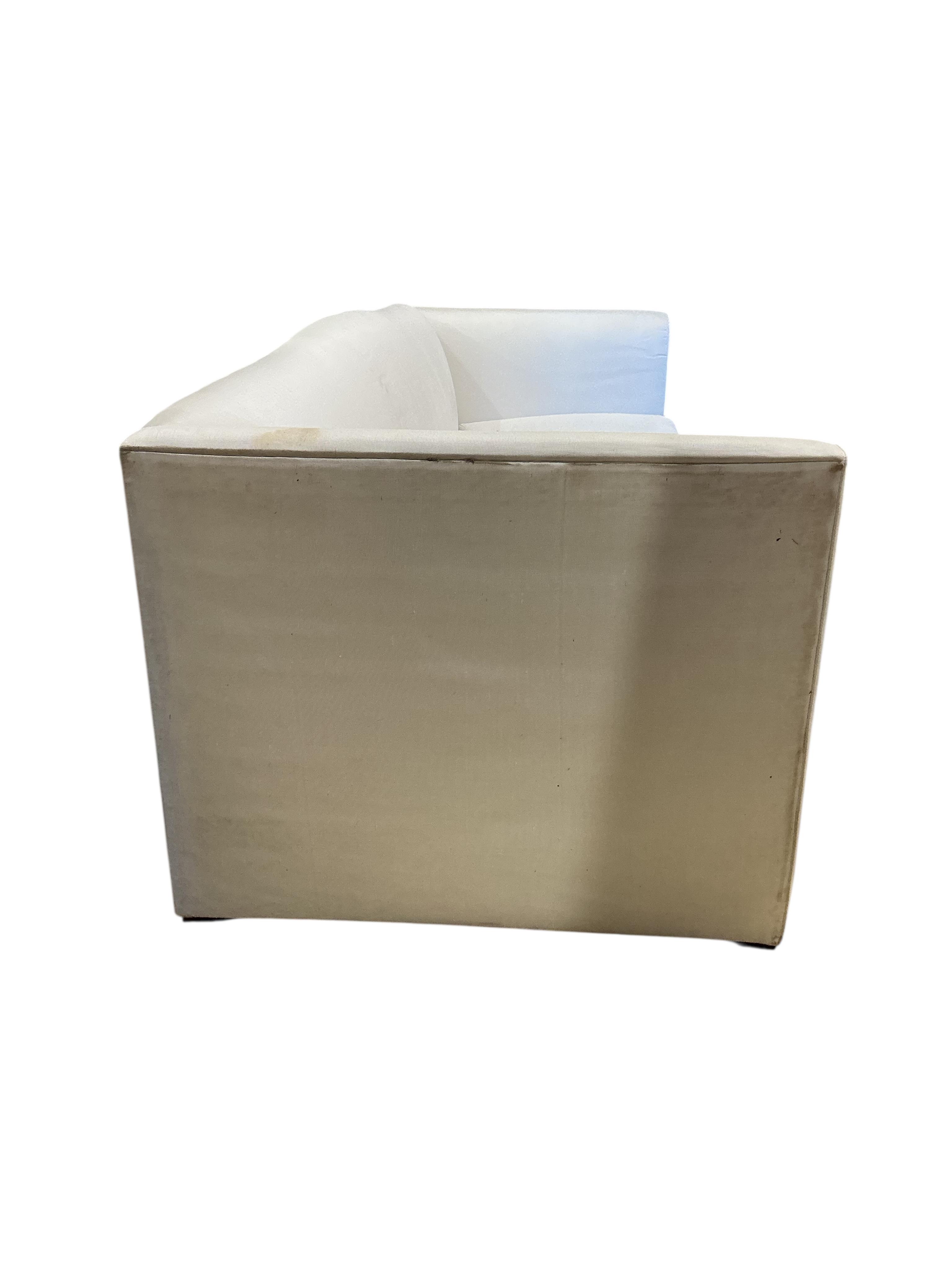 A large contemporary ivory fabric settee, width 260cm, depth 100cm, height 82cm